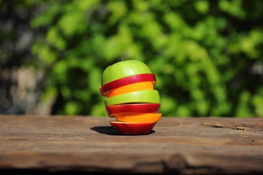 still life of apples and orange slices stacked