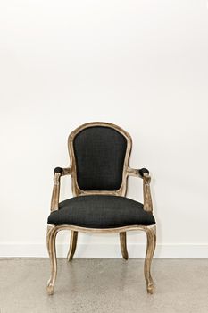 Antique upholstered armchair furniture against white wall