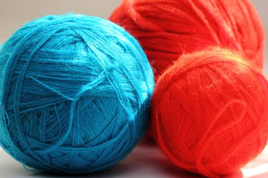 red and blue balls of yarn for needlework