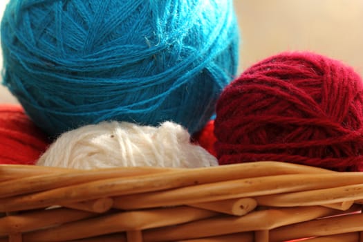 red and blue balls of yarn for needlework