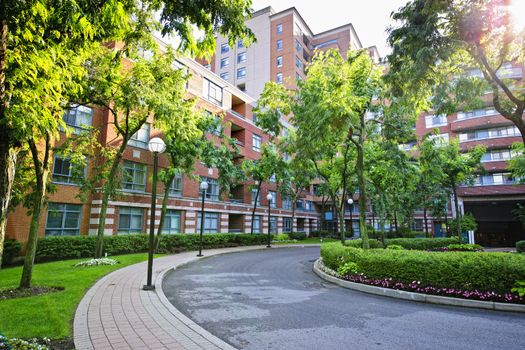 Circular driveway and sidewalk at brick condominium building