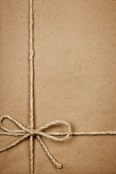 Brown paper gift package background with twine and copy space