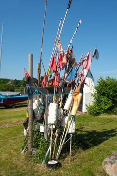 Fisherman flags and fishing equipment in a small port Denmark                               