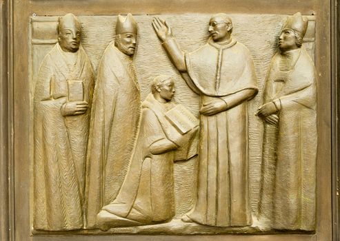 Bas-relief on the church doors the Saints Gervasio and Protasio Protasio in Domodossola, Italy