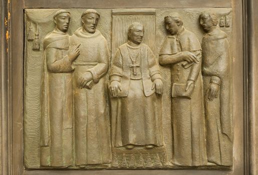 Bas-relief on the church doors the Saints Gervasio and Protasio Protasio in Domodossola, Italy