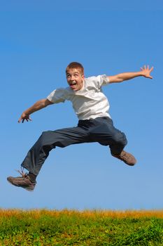 crazy young boy jumping on the blue sky background