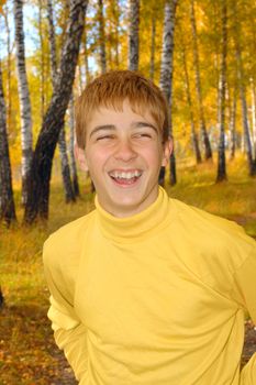 laughing boy stand in autumn forest