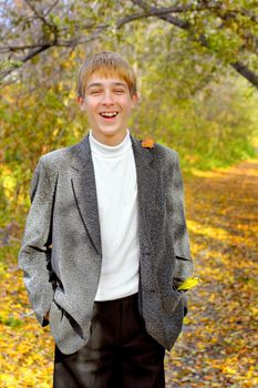 smiling teenager stand in autumn park