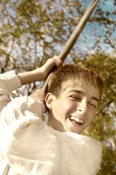 Young and happy teenager jumping on the bungee in the autumn forest