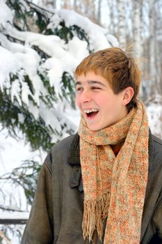 happy laughing teenager in winter forest