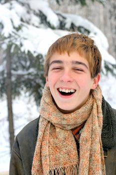 happy laughing teenager in winter forest