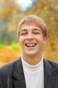 laughing boy stand in autumn forest