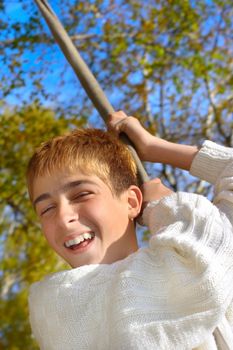 Young and happy teenager jumping on the bungee in the autumn forest