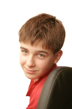 smiling young and happy boy portrait on the chair