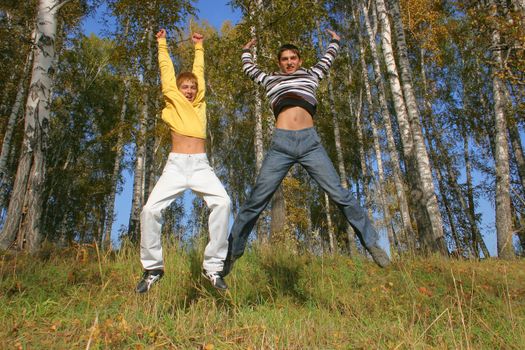 Happy smiling youth two teenage boys jumping