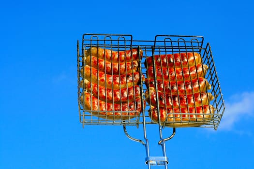 sausage grill isolated on the blue sky