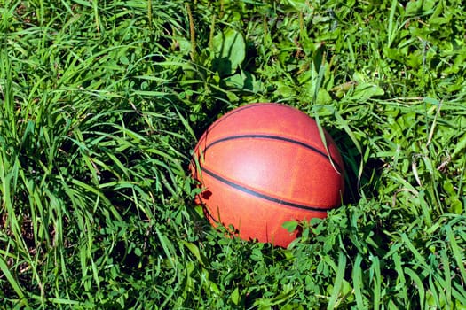 closeup of a basketball found lying on the grass