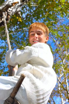 Young and happy teenager jumping on the bungee in the autumn forest