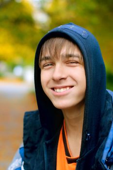 smiling teenager stand in the autumn park