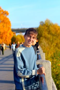 smiling teenager standing on the street