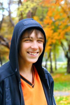 smiling teenager stand in the autumn park