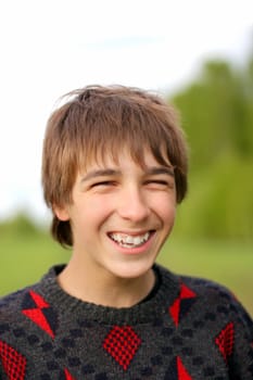 laughing teenager stand in the summer forest