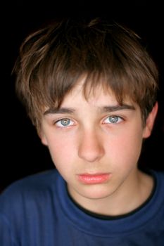 sad teenager portrait on the black background