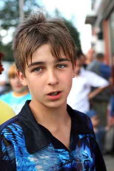 The excited boy looks aside with attention on the street