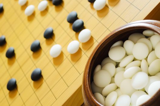 A game of go. Focus on foreground stones.
