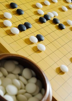 A game of go. Focus on board.