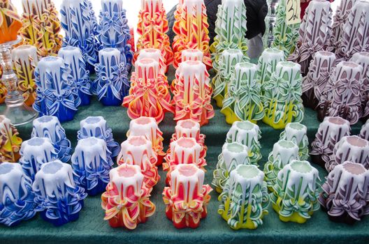 colorful decorative wax candles sell in outdoor marketplace fair.