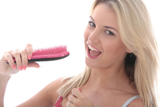 Model Released. Attractive Young Woman Singing into a Hairbrush
