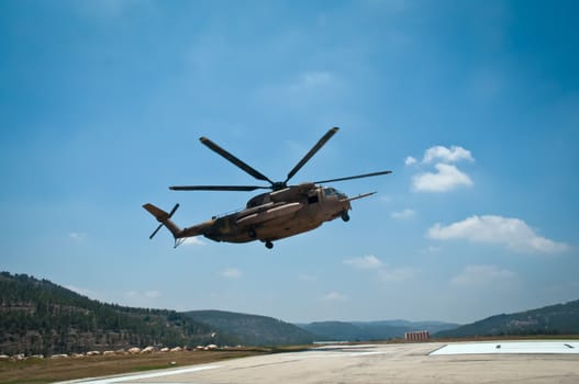 Helicopter flying over the forest near Jerusalem .