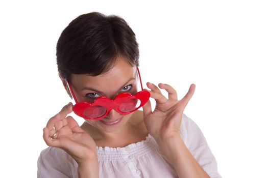 Looking-up surprised woman with funny glasses heart-shaped isolated on white