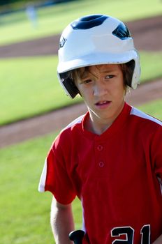 Portrait of youth baseball player with expression on his face.