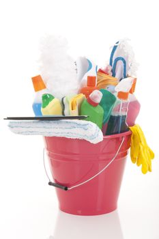 Plastic bucket with cleaning supplies on white background