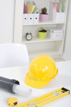 Hardhat  and measuring instruments on blueprint
