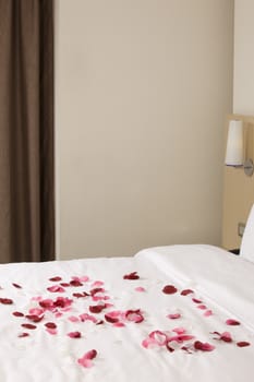 hotel room with big bed and red flowers