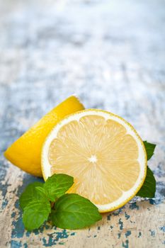 Lemon with mint on table background with copy space. Macro shot