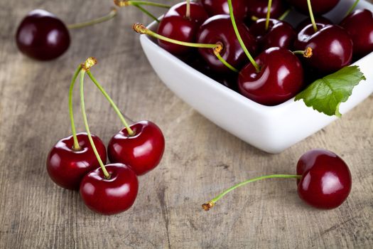 Sweet cherries in bowl on table background. Macro shot