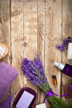 Lavender spa beauty treatment products on wooden table. Empty room for text. Top view