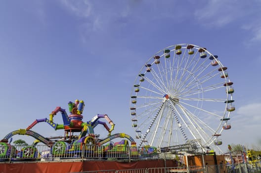 amusement park rides with blue sky background