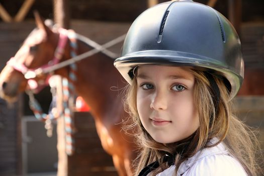 Portrait of little girl and brown Horse