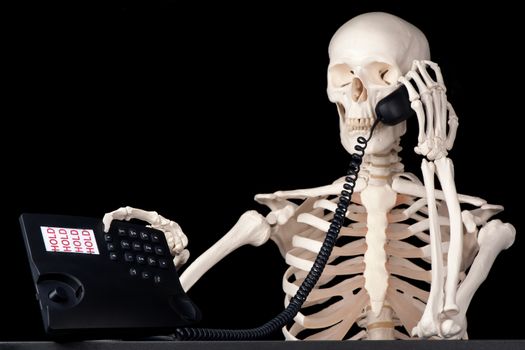 A skeletal call centre employee keeps a call on hold forever.