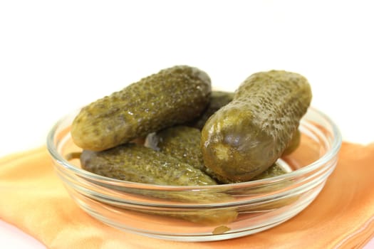 fresh green pickles in front of white background