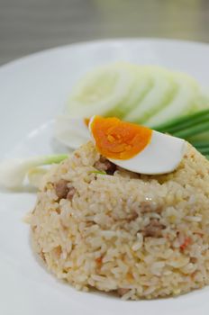  fried rice with pork and boiled egg served with fresh vegetable