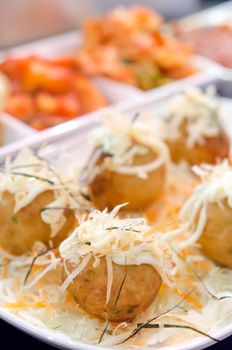 close up Takoyaki octopus balls on white plate