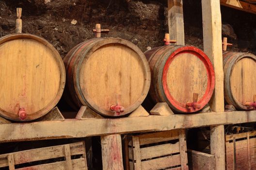 Wooden wine barrels in an underground cellar