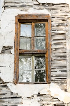 An abandoned house and a rusty window