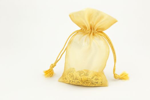 sparse golden bag and gold ornament on white background
